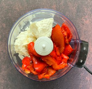 Red peppers, olive oil and feta in a food processor 